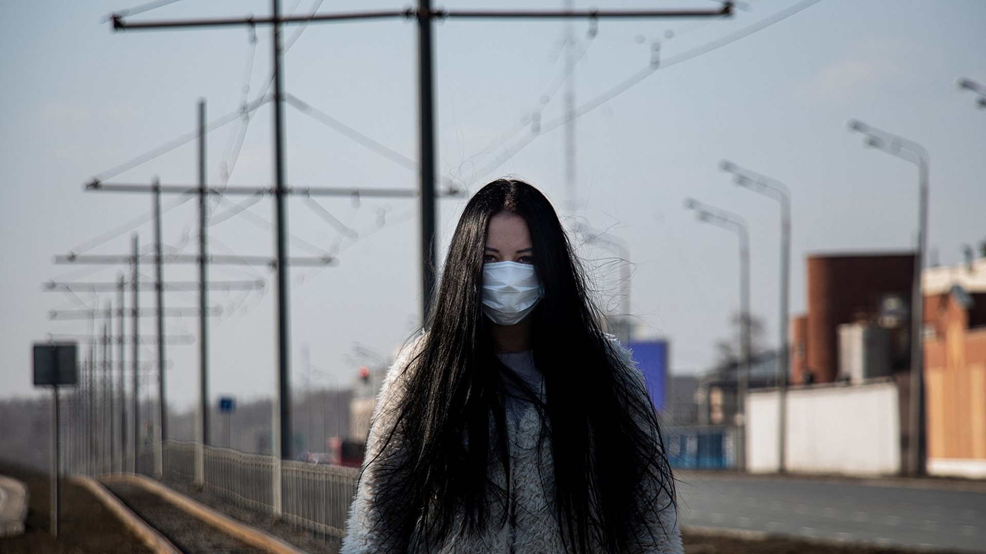 coronavirus covid-2019 Girl in mask in the street